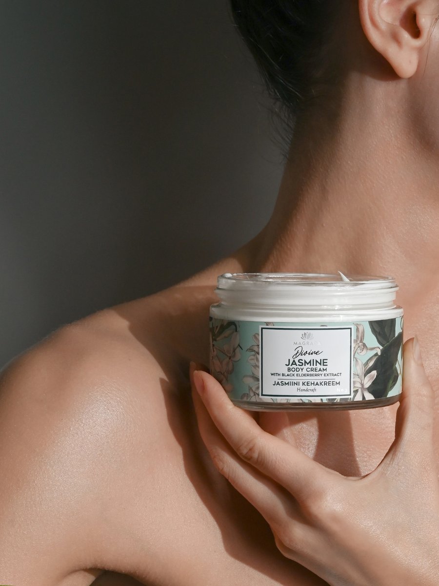 Magrada Organic Cosmetics jar held near shoulder with black elderberry extract lotion label