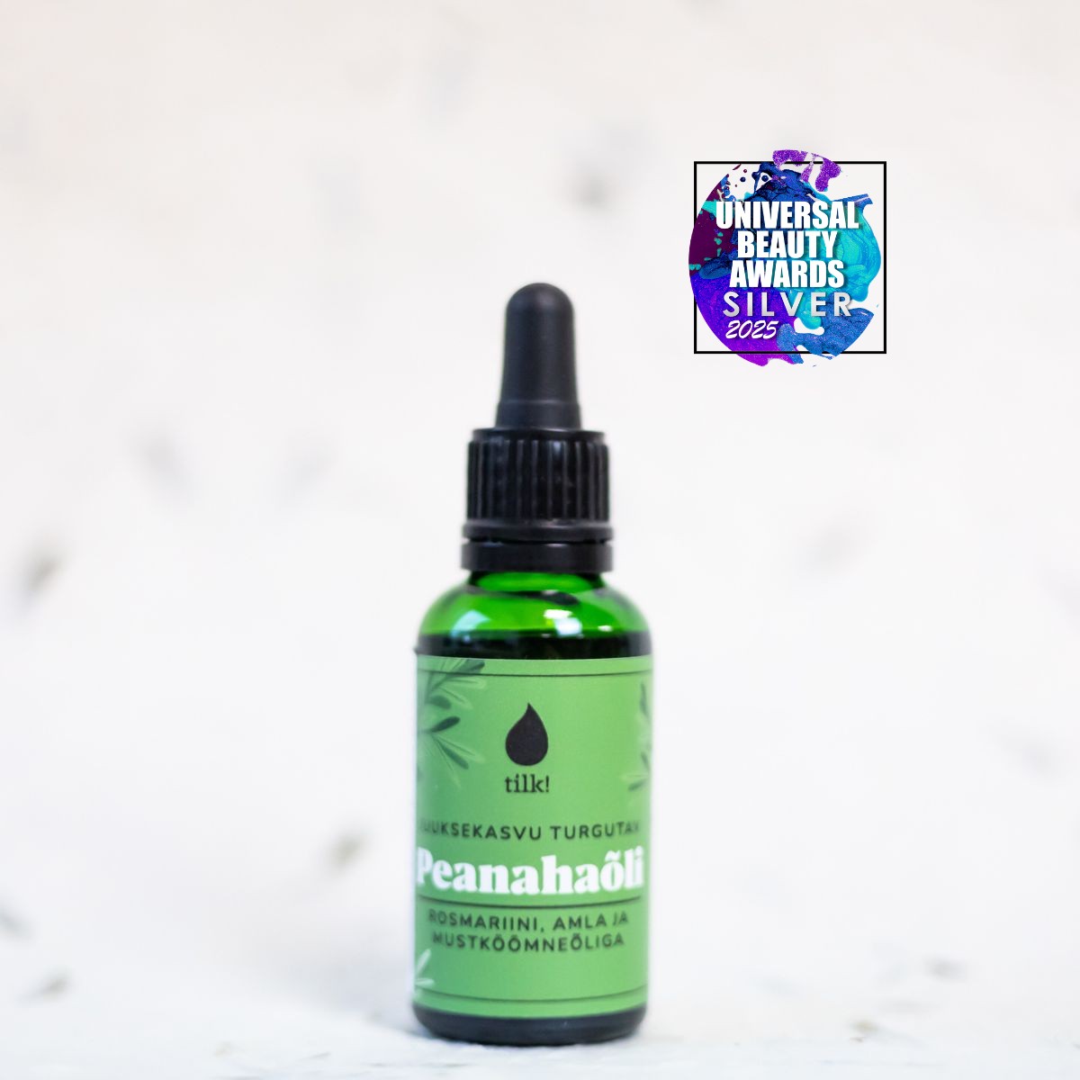 Tilk green bottle of Peanahaõli with dropper and Universal Beauty Awards Silver 2025 badge