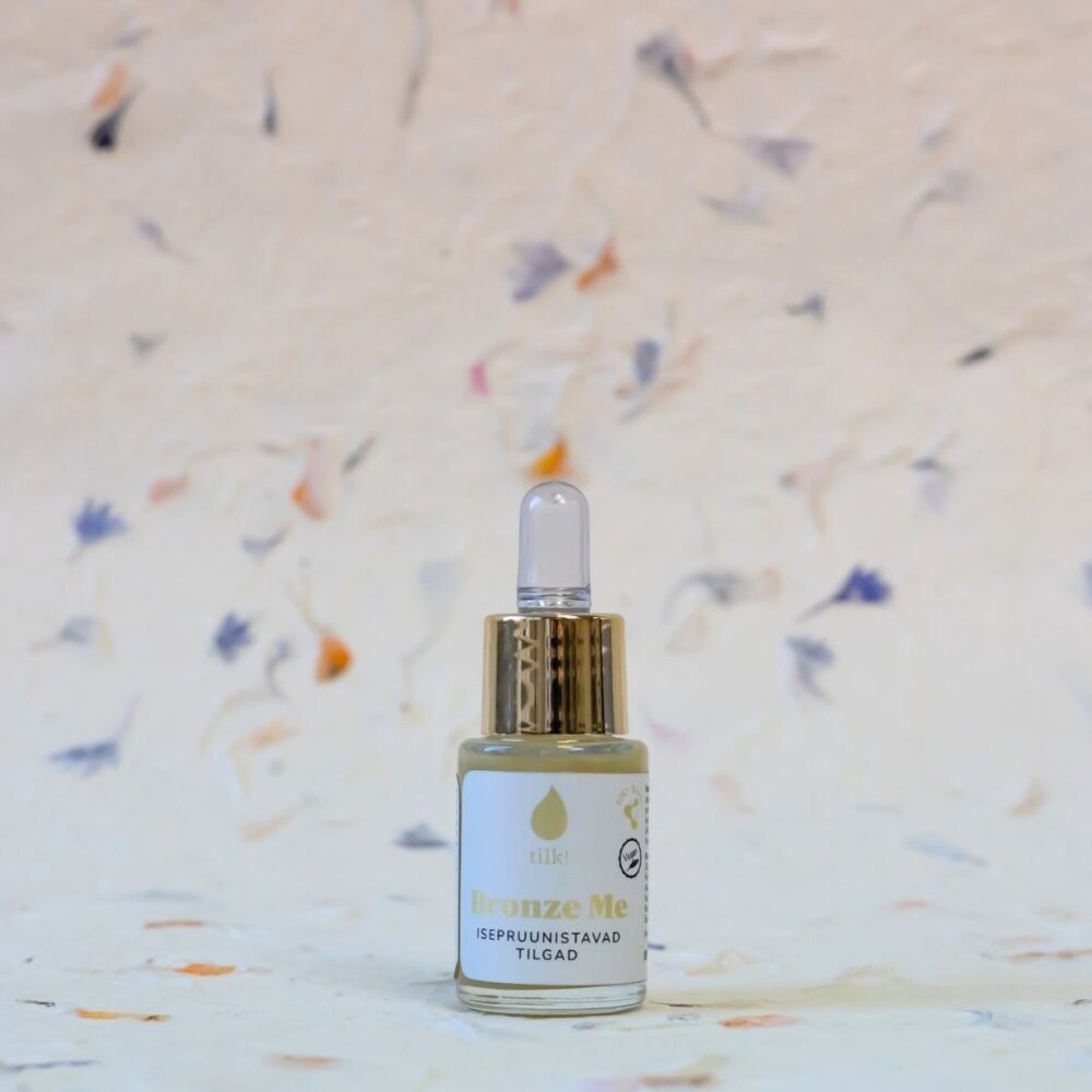 Tilk self-tanning drops with hyaluronic acid in a small bottle with a gold dropper cap