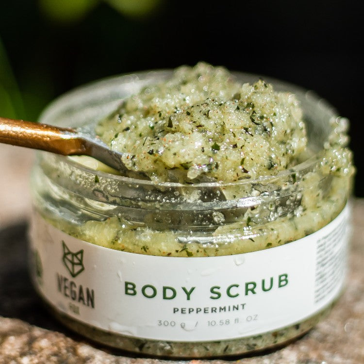 Vegan Fox peppermint body scrub in a clear jar with natural exfoliating texture and green specks